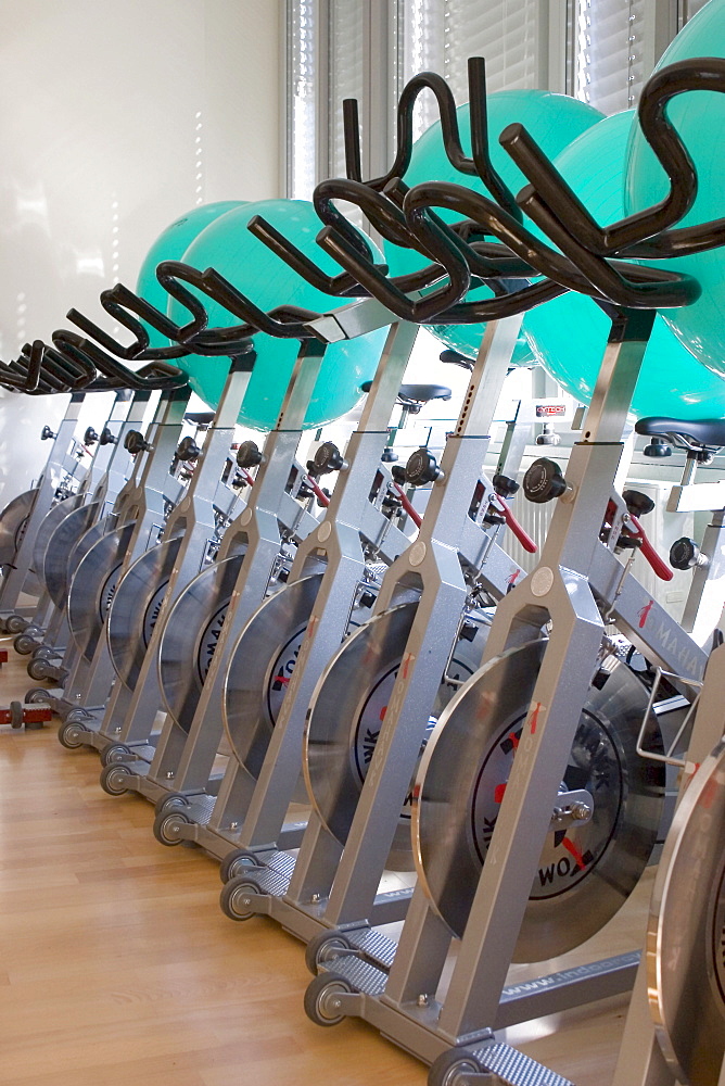 Exercise bikes standing in a fitness room