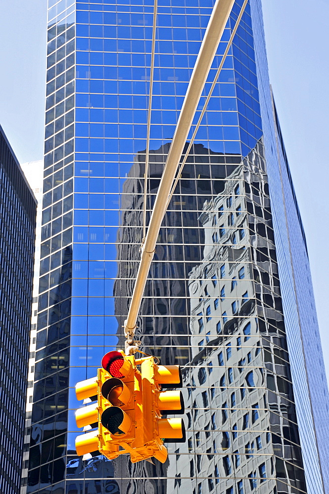 Red traffic light and reflective facade of the Broad Financial Center, Financial District, Manhattan, New York City, USA