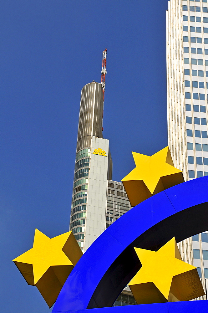 Euro symbol surrounded by stars, in front of multistory buildings, Eurotower of the European Central Bank, left of it headquarters of the Commerzbank, Frankfurt, Hesse, Germany