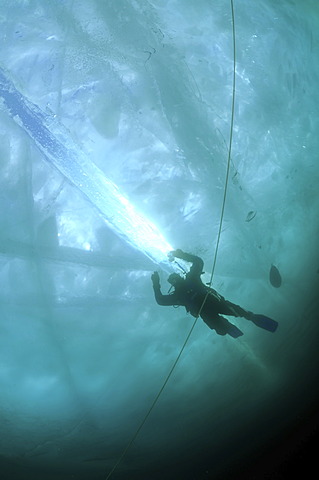 Diver, ice-diving, in Lake Baikal, Olkhon island, Siberia, Russia