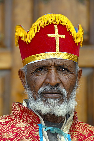 Ethiopian Orthodox Christianity portrait bishop with colourful crown in front of the New Cathedral Axum Ethiopia