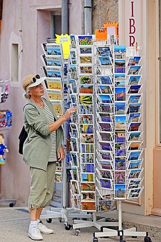 Woman looking at postcards outside a souvenir shop, Sault, Vaucluse, Provence-Alpes-Cote d'Azur, Southern France, France, Europe, PublicGround