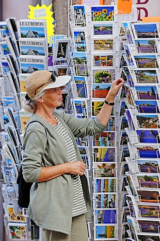 Woman looking at postcards outside a souvenir shop, Sault, Vaucluse, Provence-Alpes-Cote d'Azur, Southern France, France, Europe, PublicGround