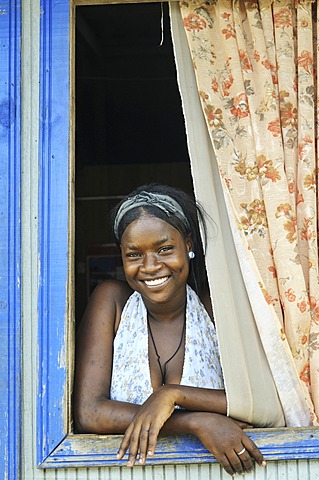 Young woman, Afro-Colombian, in the window of her house, Bajamar slum, Buenaventura, Valle del Cauca, Colombia, South America