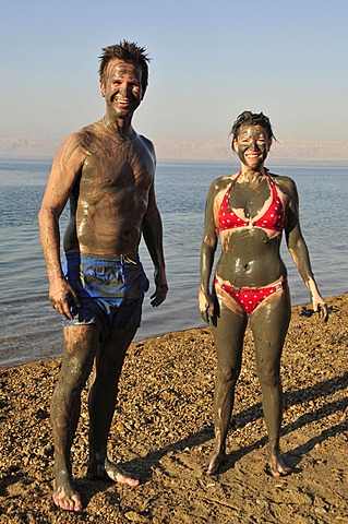 Tourists smeared with salty mud from the Dead Sea, near Suwaymah, Jordan, Middle East, Orient