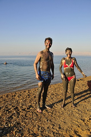 Tourists smeared with salty mud from the Dead Sea, near Suwaymah, Jordan, Middle East, Orient