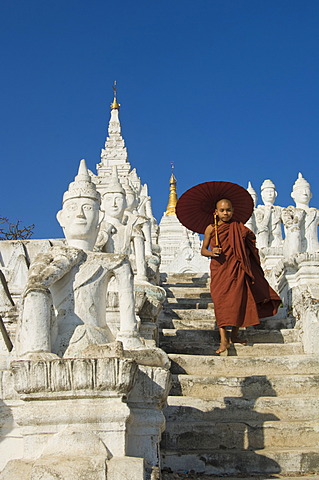 Settawya Pagoda, young Buddhist monk with a red umbrella, Mingun, Burma, Myanmar, South East Asia