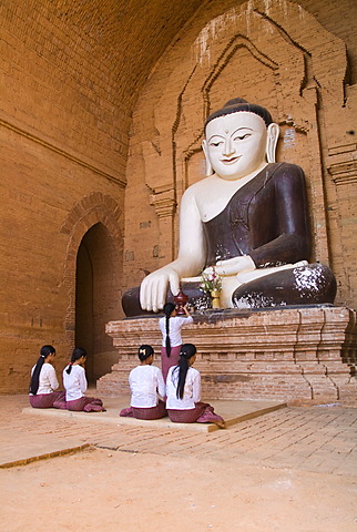 Burmese women praying to Buddha, Bagan, Myanmar