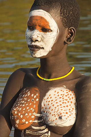 Young Surma woman with body painting in the river, Kibish, Omo valley Valley, Ethiopia, Africa