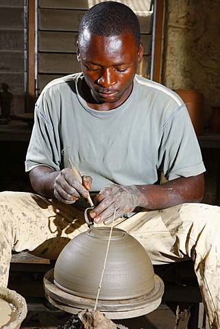 Man working at a potter's wheel producing pottery, Bamessing, Cameroon, Africa