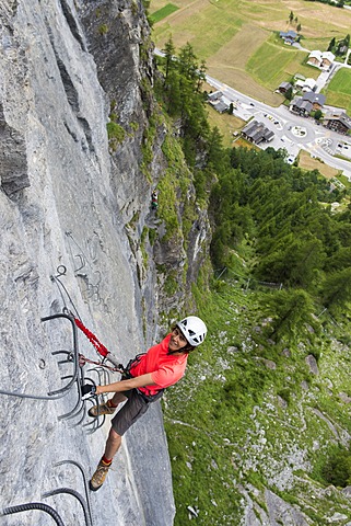 Female climber on the fixed rope route "Via ferrata d'Evolene Region", EvolâˆšÂ®ne, Canton of Valais, Switzerland