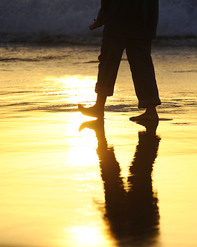 Legs walking along a beach, backlighting, near El Cotillo, Fuerteventura, Canary islands, Spain, Europe