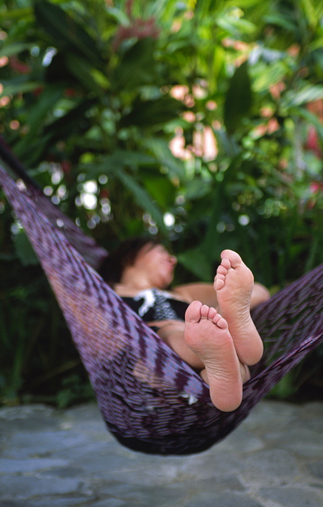 A woman is relaxing in a hammock, Costa Rica, Central America