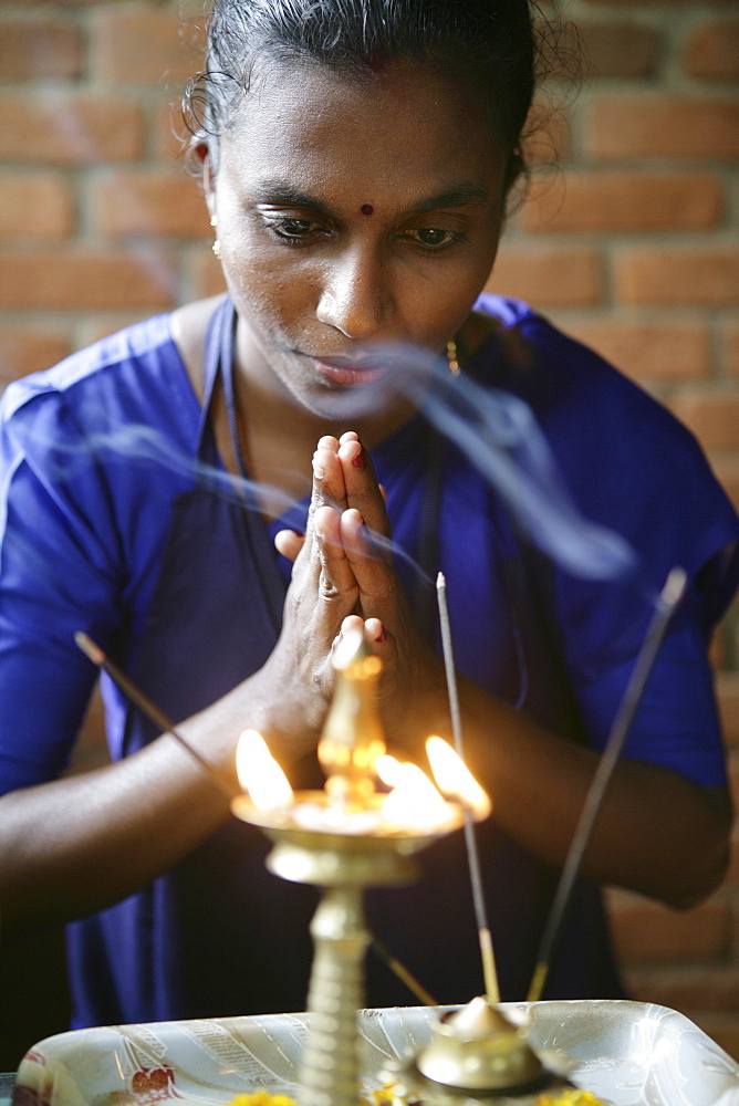 Woman praying before incense, Somatheeram Ayurveda Resort, traditional Ayurvedic medicine spa resort in Trivandrum, Kerala, India, Asia