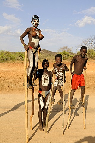 Boys of Ari tribe walking on stilts, Omo Valley, Ethiopia, Africa