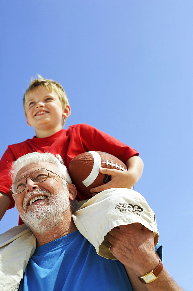 Grandfather and grandson with football