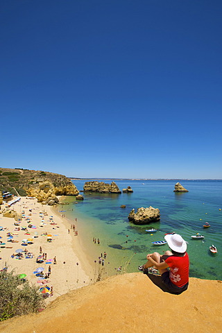 Woman overlooking Praia Dona Ana near Lagos, Algarve, Portugal, Europe