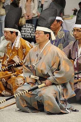 Archers kneeling in the Shrine courtyard after devotion at the archery ceremonial in Shimogamo Shrine, Kyoto, Japan, Asia