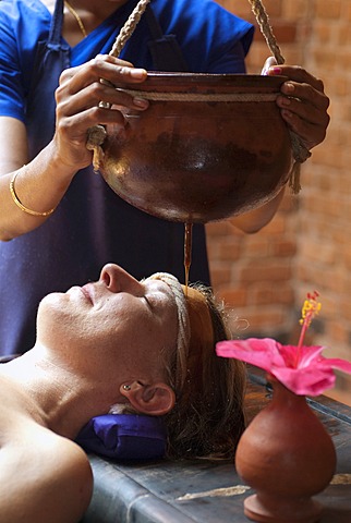 Woman receiving Ayurvedic treatment, Shirodhara, oil is gently poured over the forehead, Somatheeram Ayurvedic Health Resort, Chowara, Malabar Coast, South India, India, Asia