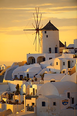 Windmills and town at sunset, Oia, Ia, Santorini, Cyclades Islands, Greece, Europe