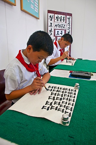 Selected children practicing calligraphy in the Children's Palace, Pyongyang, North Korea, Asia