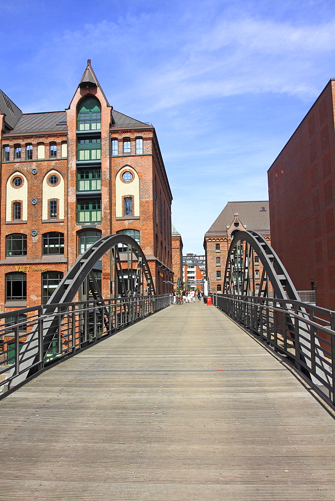 Bridge crossing a fleet with old buildings in the Speicherstadt, the historic warehouse district, Hanseatic City of Hamburg, Germany, Europe