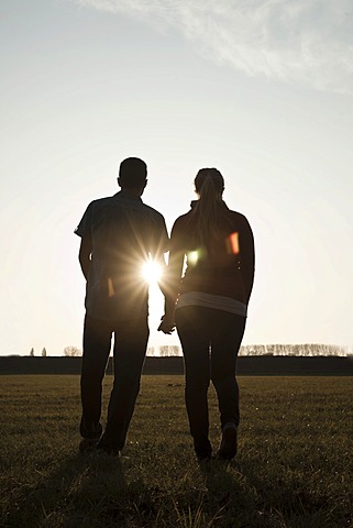 Young couple on a walk outdoors, in nature