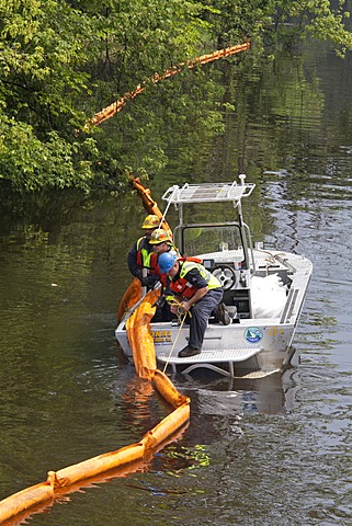 Workers place containment boom on the Kalamazoo River to contain an oil spill during which 800, 000 gallons of oil spilled from an Enbridge Energy Partners pipeline, Battle Creek, Michigan, USA