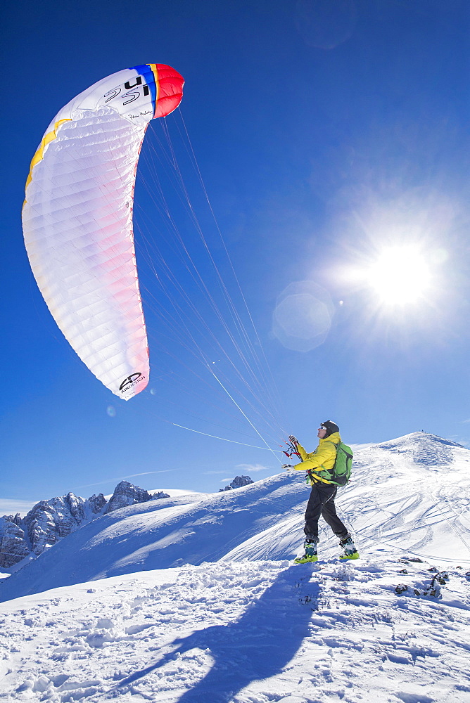 Paraglider, man preparing glider for takeoff, Axamer Lizum, Innsbruck, Tyrol, Austria, Europe