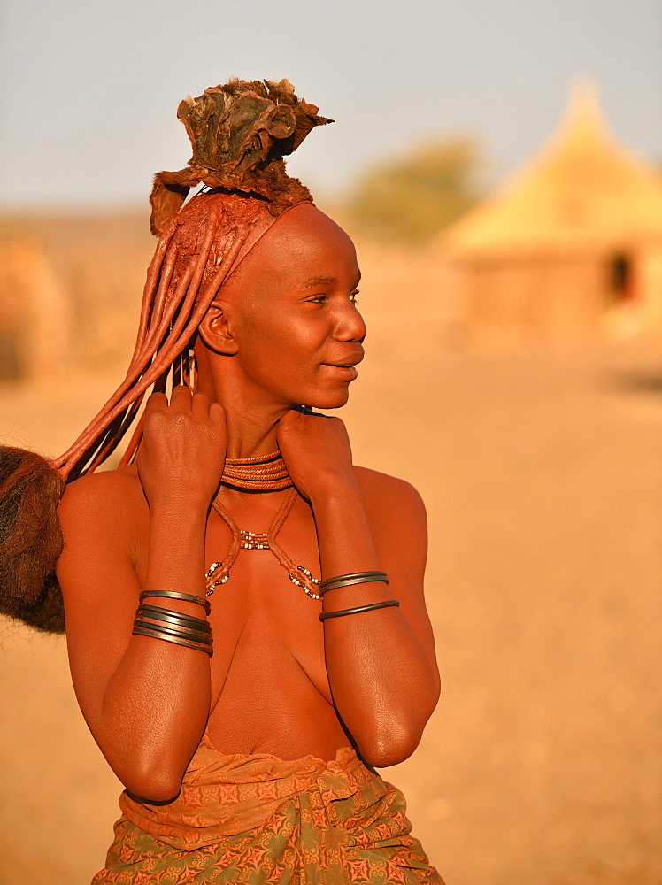 Portrait of a young, married Himbafrau with hair ornaments, Kaokoveld, Namibia, Africa