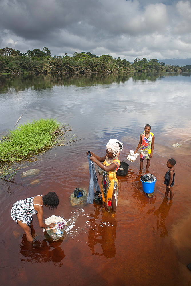 Women washing clothes in the river Ntem, in the rainforest, Campo, Southern Region, Cameroon, Africa