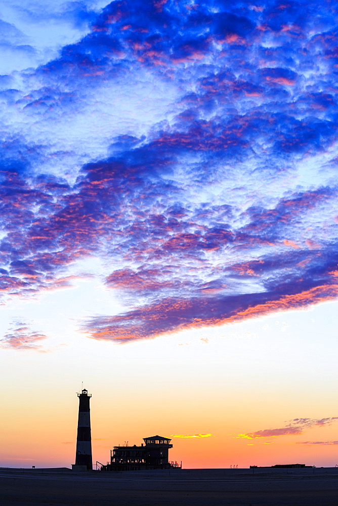 Silhouettes, Lighthouse and Lodge at sunset, Pelican Point, Walvis Bay, Erongo region, Namibia, Africa