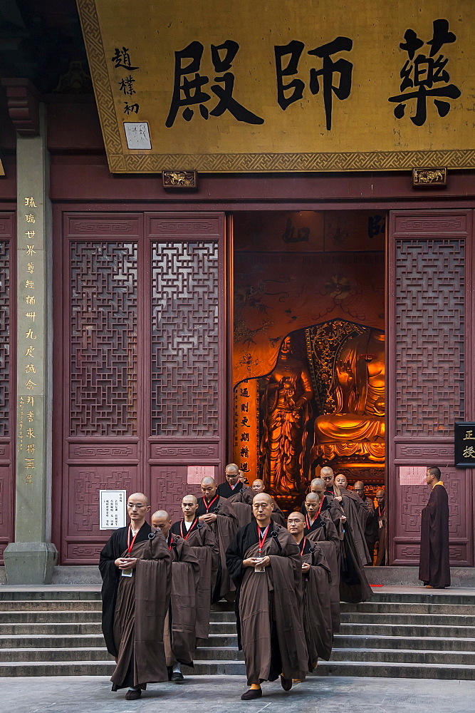 Devout monks leaving a temple, Lingying Monastery, Xihu, Hangzhou, Zhejiang Province, China, Asia