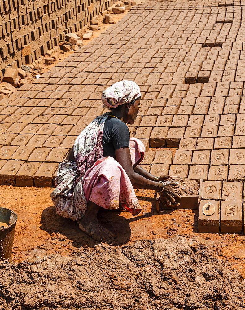 Indian woman producing adobe bricks, Usilampatti, Tamil Nadu, India, Asia