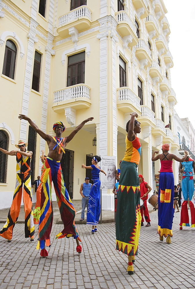 Street performers walking on stilts in Old Havana, Havana, Cuba, Central America