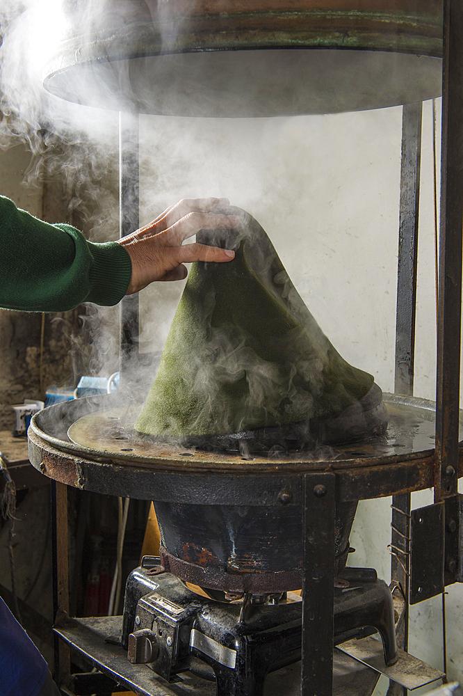 Hand taking hat bodies out of steam boiler, hatmaker workshop, Bad Aussee, Styria, Austria, Europe