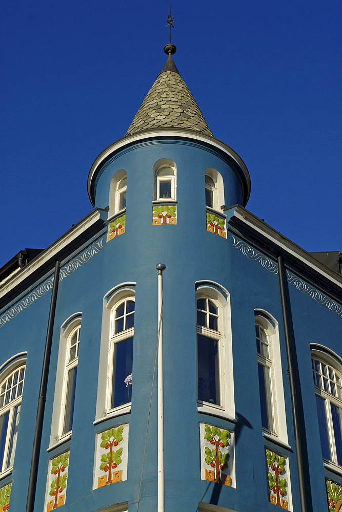 Typical blue Art Nouveau building with a small tower in downtown Alesund, Alesund, Moere og Romsdal, Norway, Europe