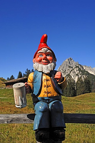 Garden gnome holding a beer mug on Litzlalm, alp, Mt Muehlsturzhoerner at back, Zell am See, Austria, Europe