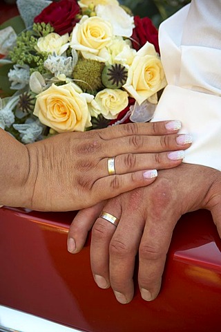 Wedding, bridal bouquet on a Cadillac