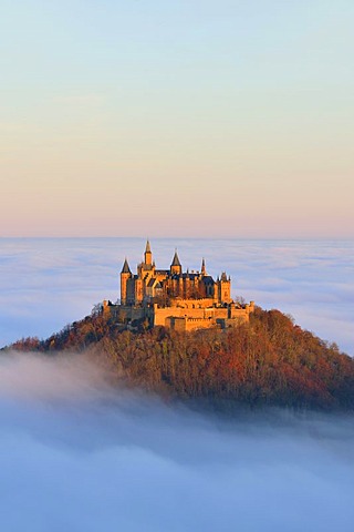 Burg Hohenzollern castle, in morning light, mist, with autumn forest, Schwaebische Alb, Swabian Alb, Baden-Wuerttemberg, Germany, Europe