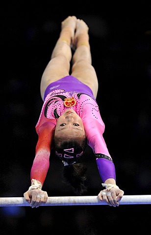 Qiushuang Huang, CHN, performing on uneven bars, EnBW Gymnastics World Cup, 11 to 13 Nov 2011, 29th DTB Cup, Porsche-Arena, Stuttgart, Baden-Wuerttemberg, Germany, Europe