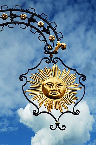 Hanging sign of "Hotel Gasthof Sonne", restaurant and hotel, against a cloudy sky, Hauptstrasse, Gengenbach, Baden-Wuerttemberg, Germany, Europe