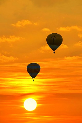 Hot-air balloons against the setting sun, Suedschwarzwald, Southern Black Forest, Baden-Wuerttemberg, Germany, Europe, composing