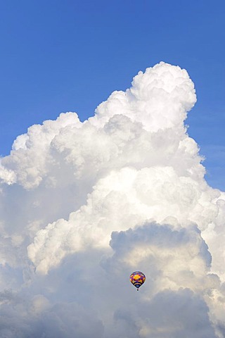 Hot-air balloon against white clouds, cumulus clouds, Suedschwarzwald, Southern Black Forest, Baden-Wuerttemberg, Germany, Europe