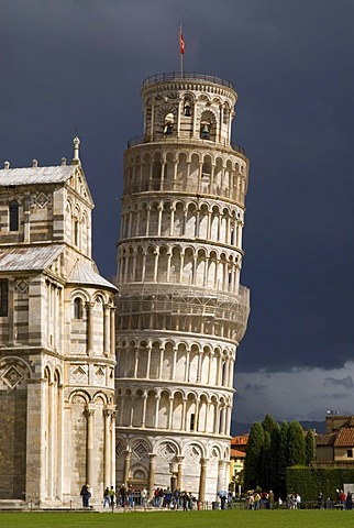 The Leaning Tower of Pisa against dark clouds, Tuscany, Italy, Europe