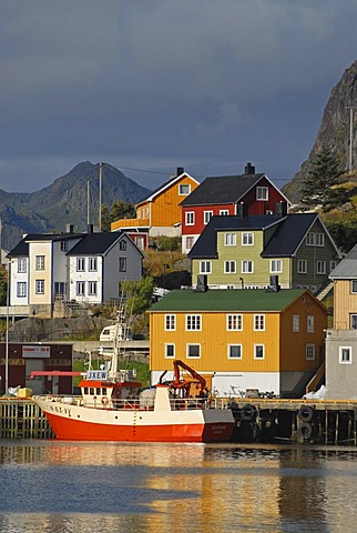 The boats and houses of Stamsund illuminated by warm morning light, Nordland, Norway, Europe