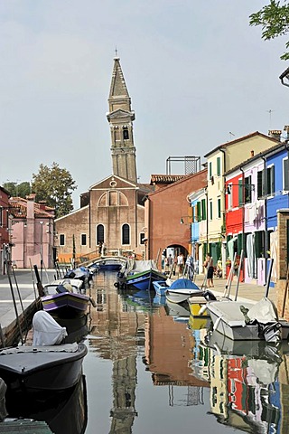 Colourfully painted houses, leaning church tower, boats on the canal, Burano, an island in the Venetian Lagoon, Italy, Europe