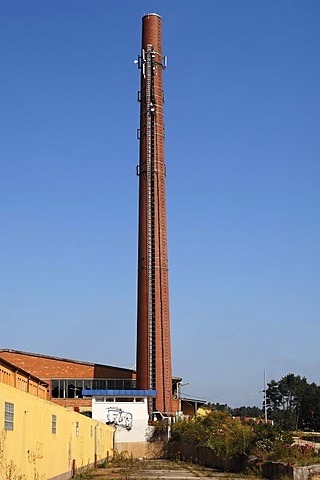 Transmission facilities on the old chimney of a dilapidated brick factory against the blue sky, Spardorf, Middle Franconia, Bavaria, Germany, Europe