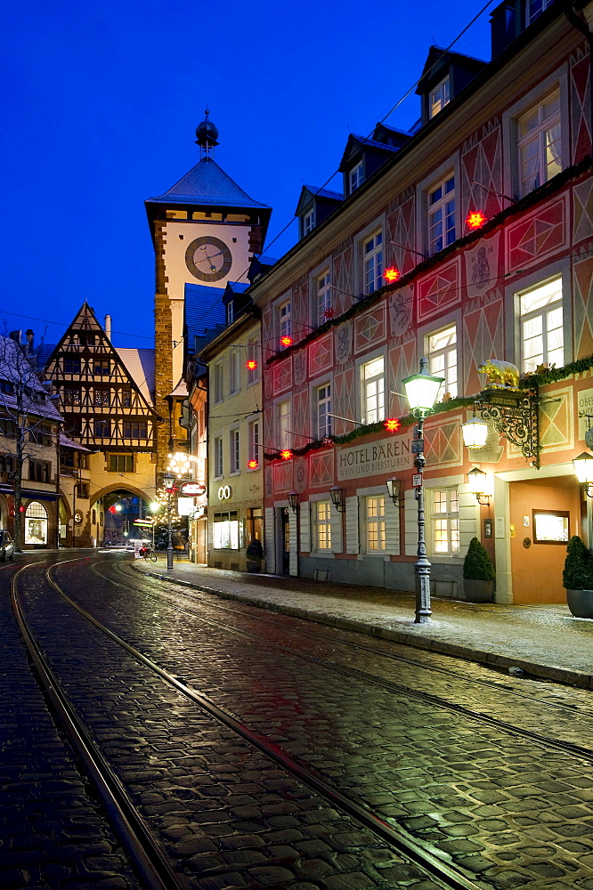 Schwabentor gate tower and Christmassy and snowy old town of Freiburg im Breisgau, Black Forest, Baden-Wuerttemberg, Germany, Europe