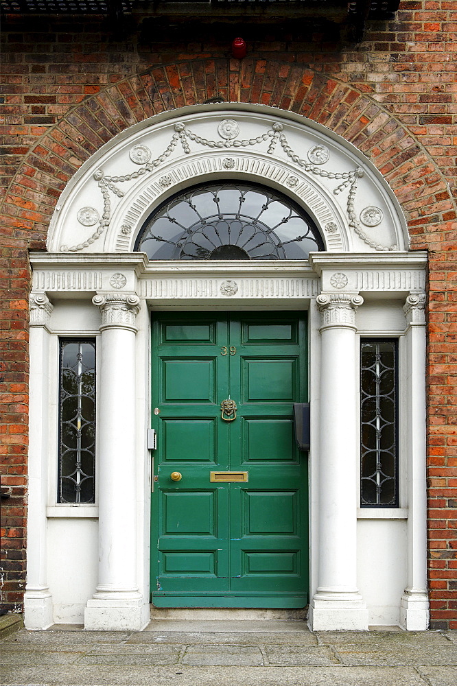 Green front door of a terraced house near Merrion Park, Dublin, Republic of Ireland, Europe